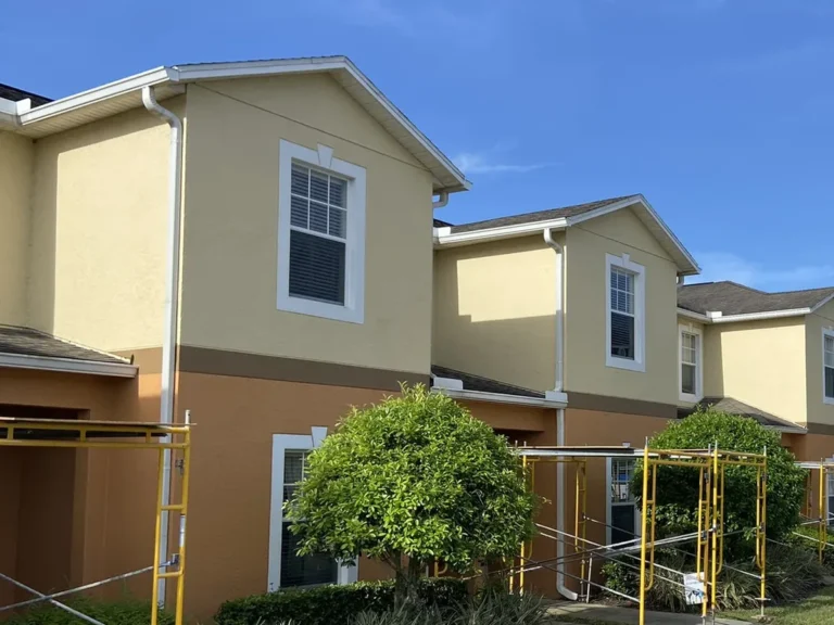 Scaffolding staged along a condominium building elevation during a 36-building reroof