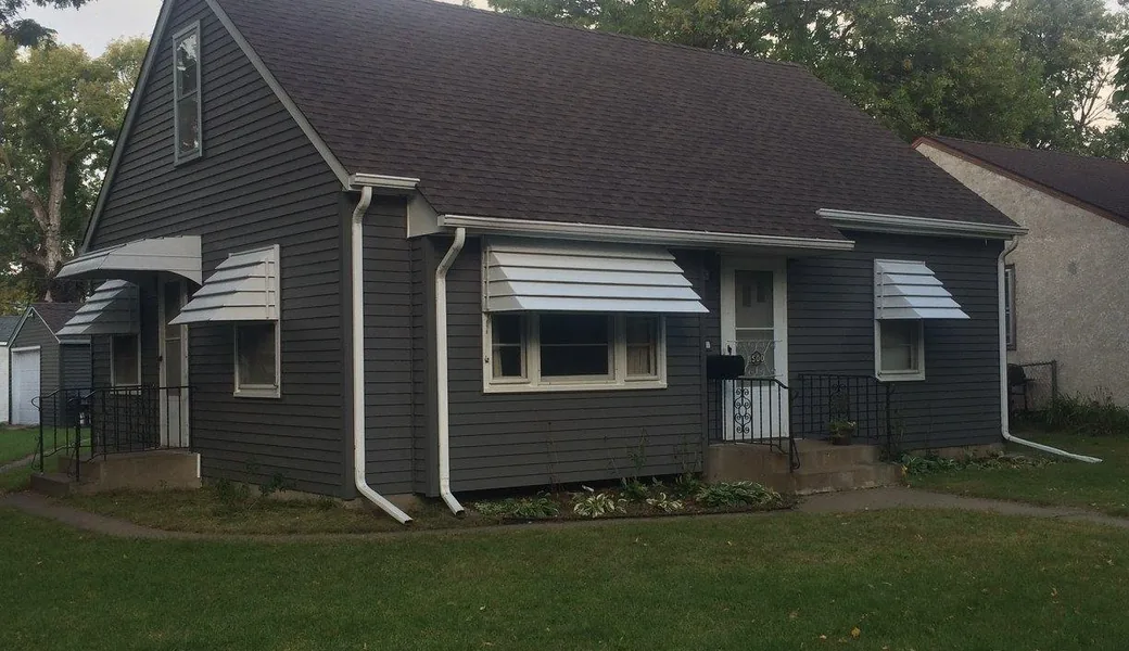 Fiber-cement siding, exterior paint and a new roof in charcoal with white trim, Blaine MN