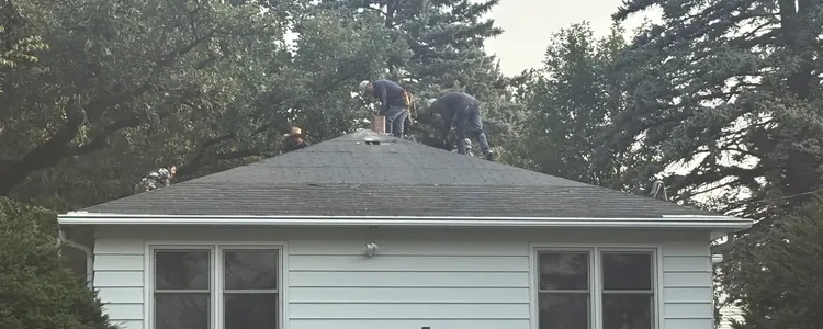 Right Away Construction crews working on a roof tear off at the rear elevation of a Northeast Minneapolis home.