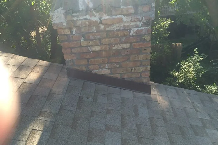 New chimney step flashing and counter flashing installed on a Minnetonka roof.