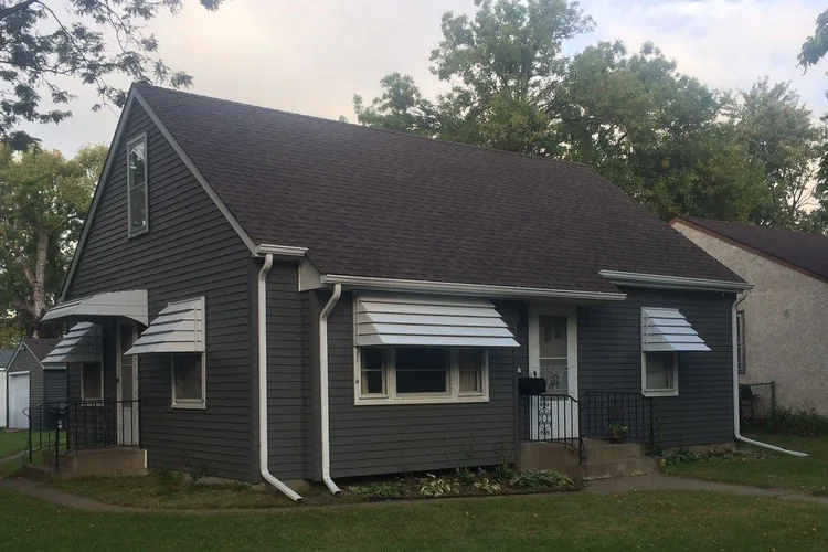 Fiber-cement siding, exterior paint and a new roof in charcoal with white trim, Blaine MN