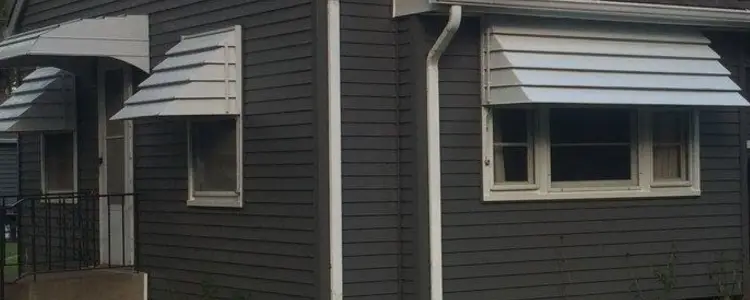 Fiber-cement siding, exterior paint and a new roof in charcoal with white trim, Blaine MN