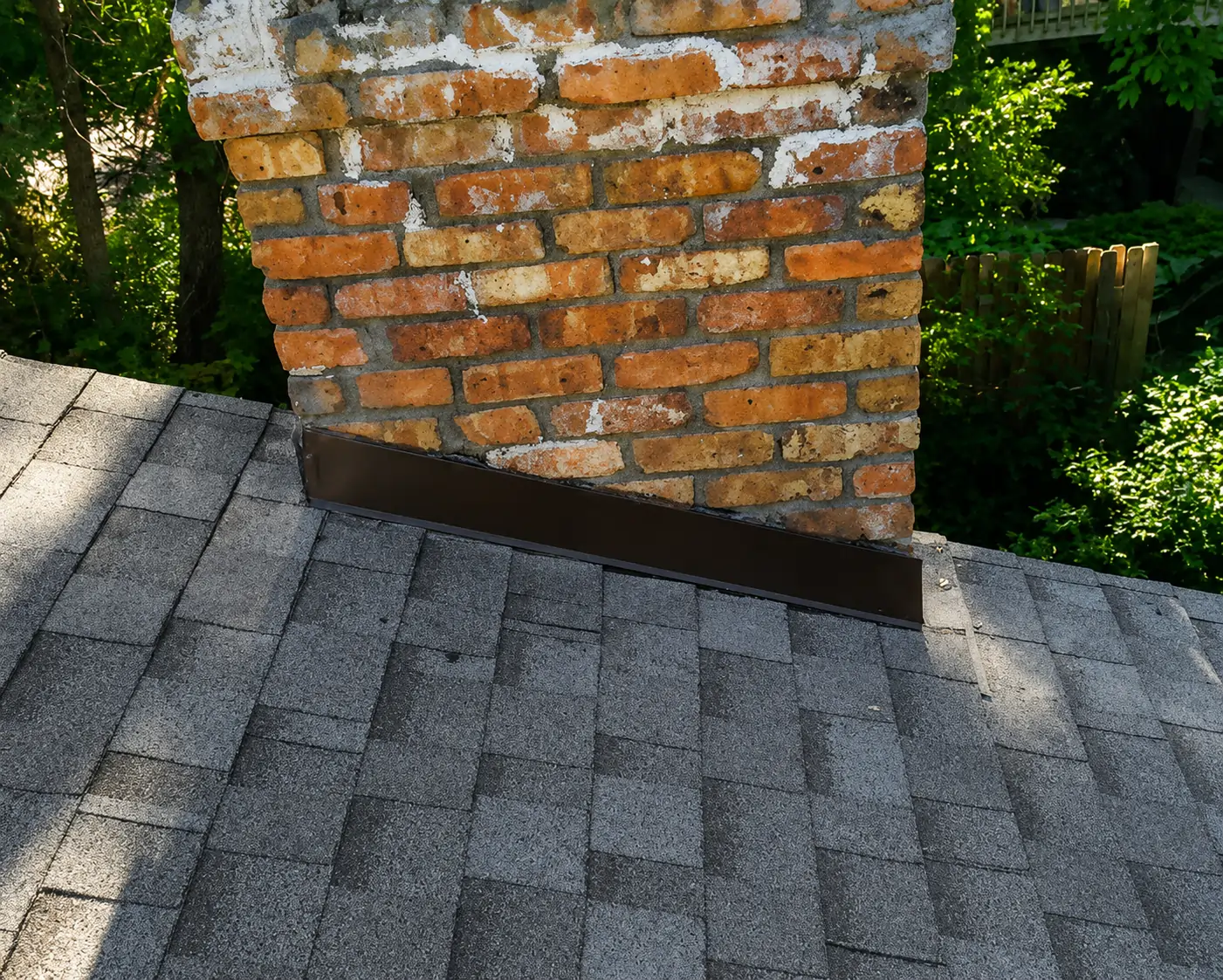 Close-up of new chimney step flashing on a newly shingled roof in Minnetonka, MN installed by Right Away Construction