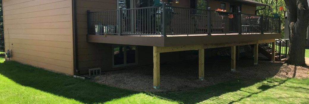 New roof, siding, and raised deck with black aluminum railings on a Roseville, MN home built by Right Away Construction