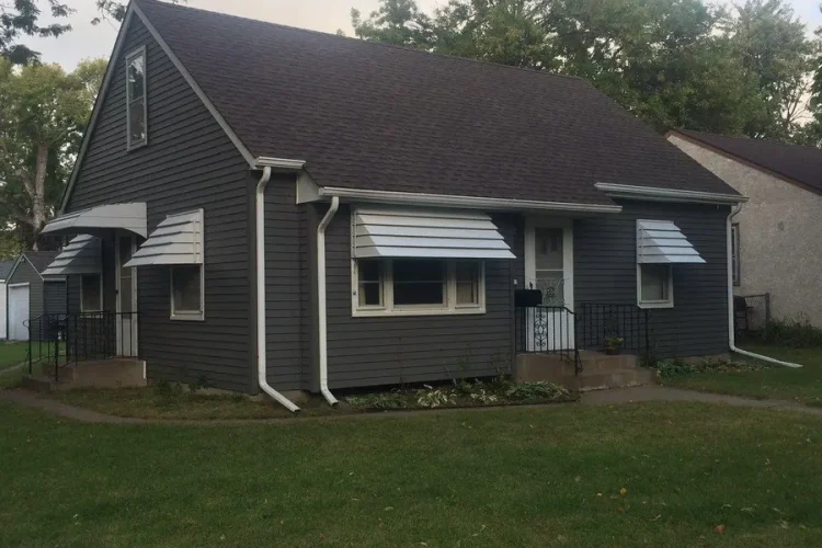 Fiber-cement siding, exterior paint and a new roof in charcoal with white trim, Blaine MN