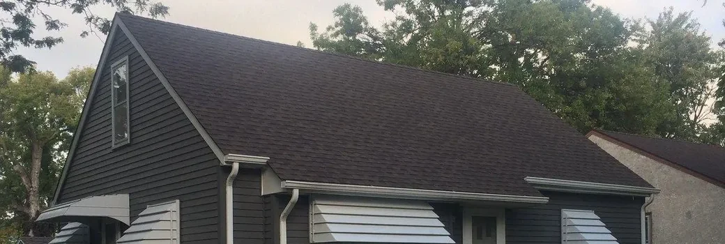 Blaine MN home with a new roof, charcoal fiber cement siding and white trim