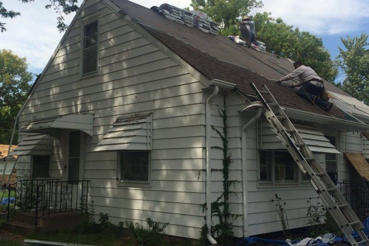Right Away Construction crew installing a new GAF Timberline asphalt shingle roof on a Blaine, MN home